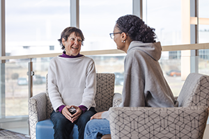Martha Rosenau sitting with a client consulting
